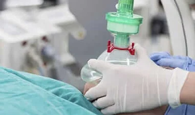 Doctor applying a breathing mask to a patient