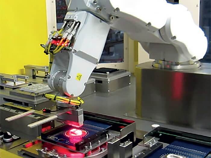 Robotic arm assembling a machine