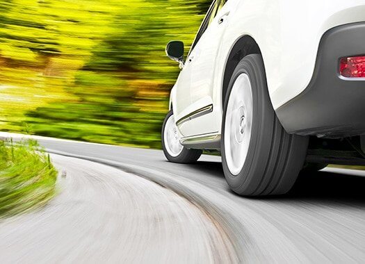 A speeding car in a forest setting