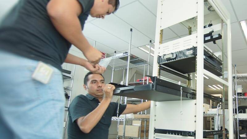 Test engineers assembling a test station