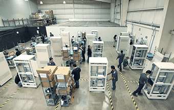 people working on a build-to-print production floor